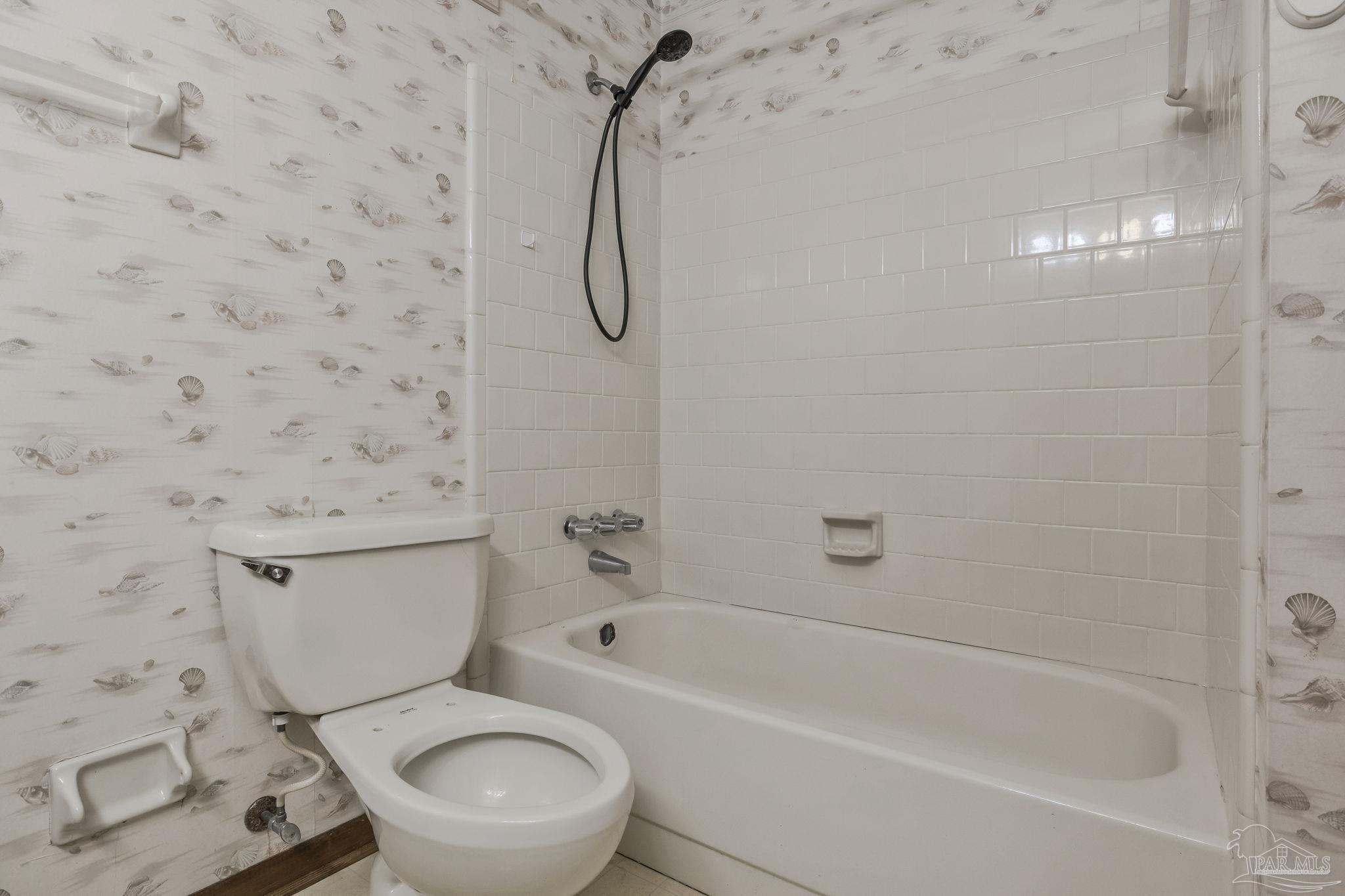 4411 Pace Lane Pace, FL 32571 - Photo 59 of 68 a white toilet sitting next to a bath tub and a shower