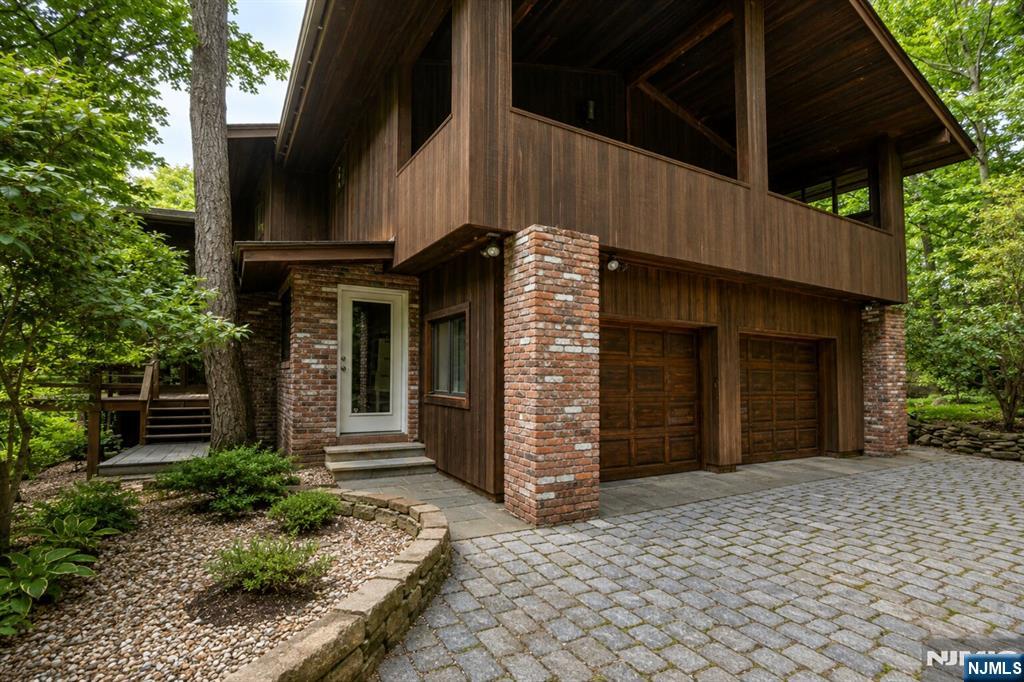 34 Cambridge Way Alpine, NJ 07620 - Photo 3 of 48 a view of a house with a door and wooden walls