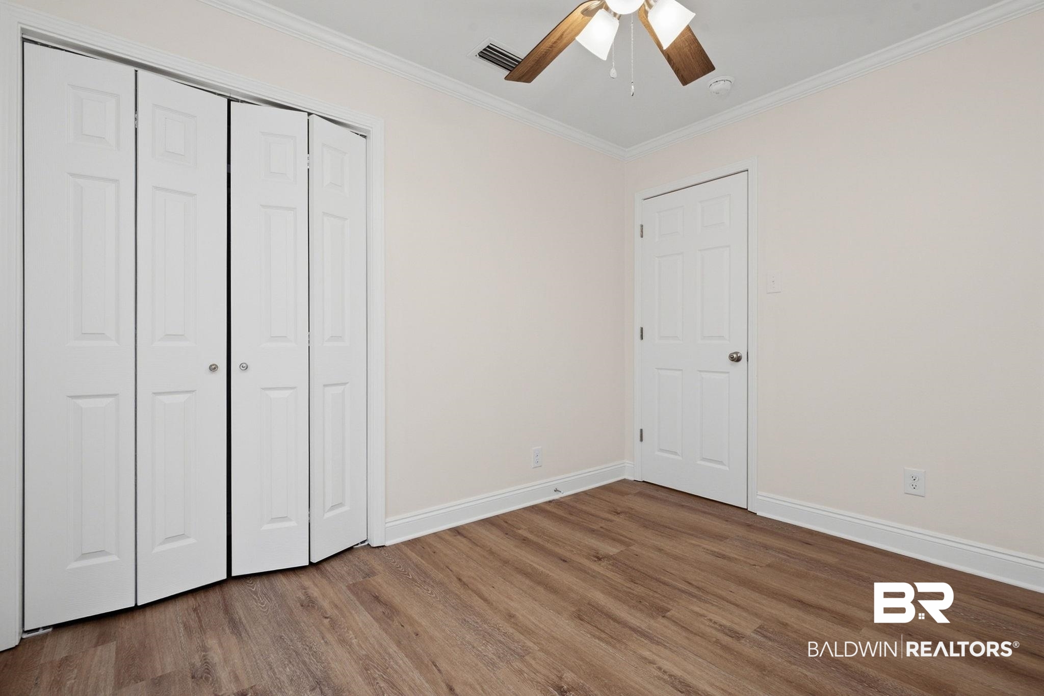 814 Nassau Drive Mobile, AL 36608 - Photo 19 of 44 Unfurnished bedroom featuring dark wood finished floors, crown molding, a closet, and a ceiling fan