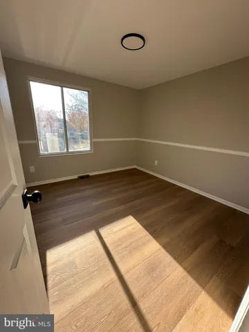 a view of an empty room and a window