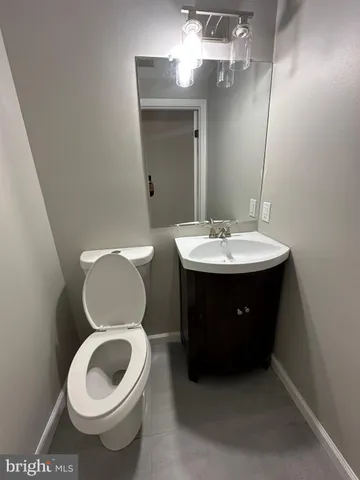 a bathroom with a toilet a sink and a mirror