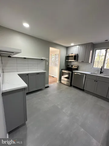 a large kitchen with cabinets and stainless steel appliances