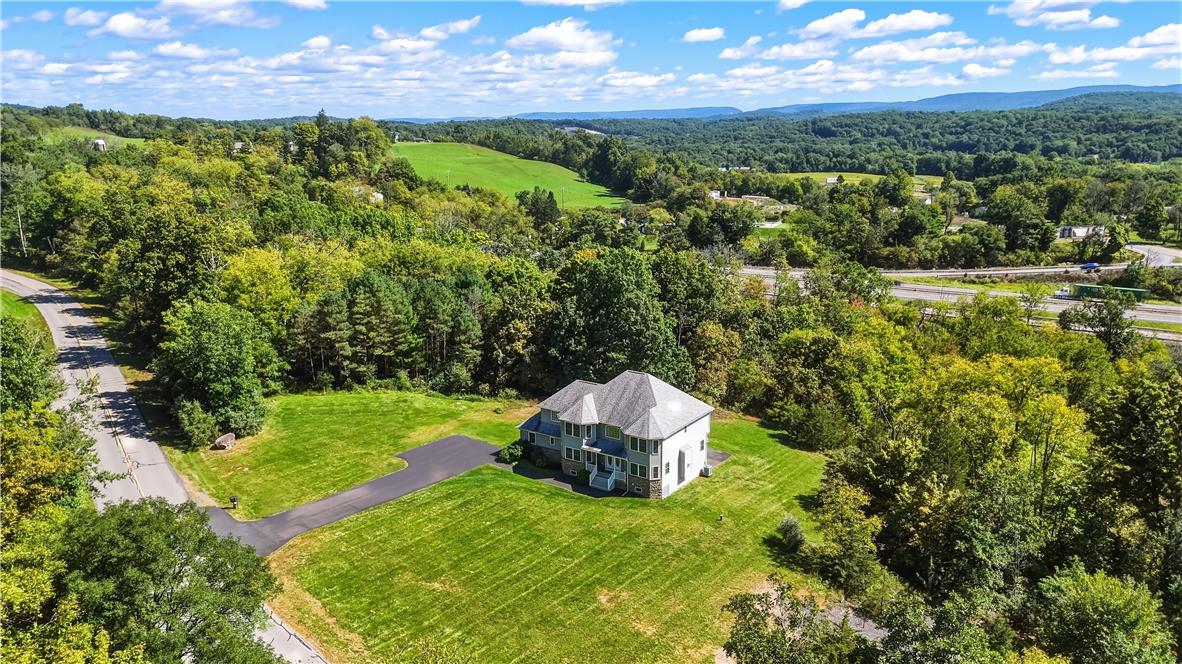 1657 Rachel Road Stroudsburg, PA 18360 - Photo 41 of 46 An aerial perspective captures the multi-level residence resting on a grassy lawn bordered by dense trees.