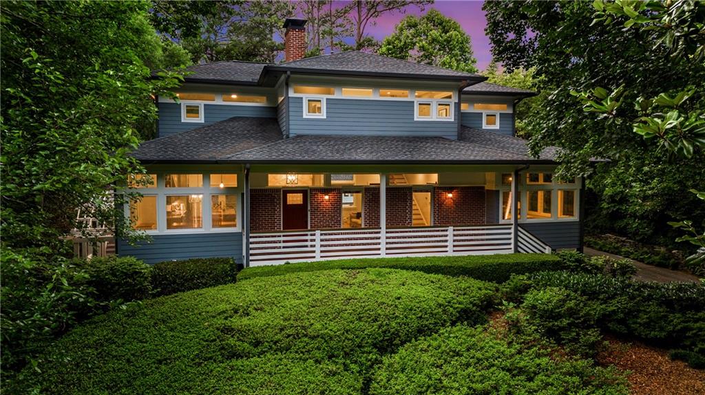 a front view of house with a garden