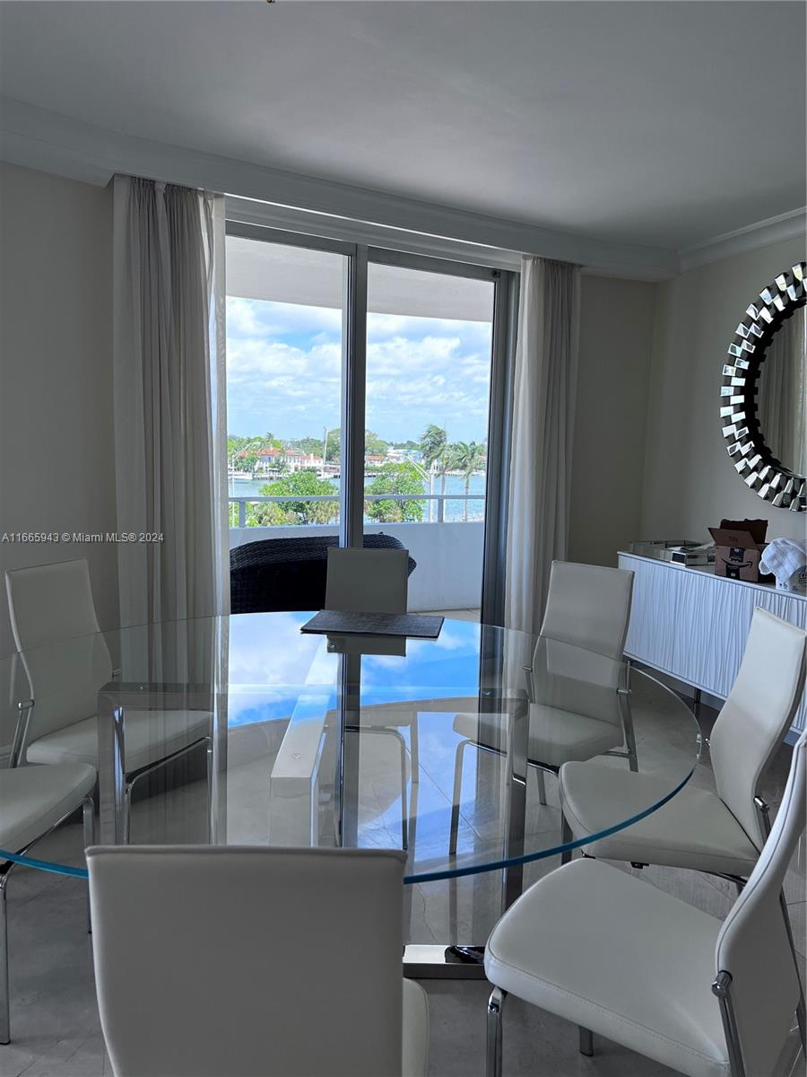 5161 Collins Avenue, Unit 505 Miami Beach, FL 33140 - Photo 15 of 31 a living room with furniture and a large window