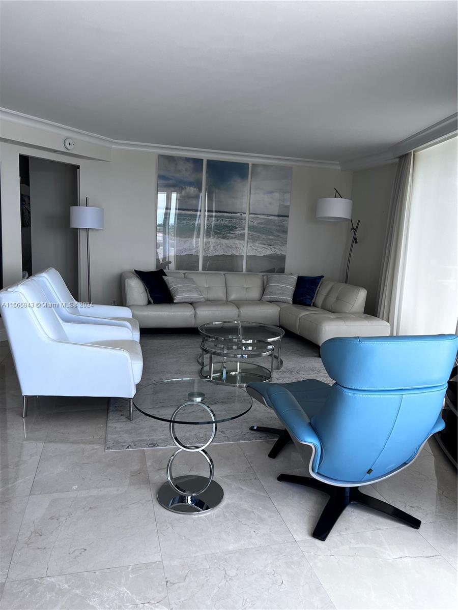 5161 Collins Avenue, Unit 505 Miami Beach, FL 33140 - Photo 18 of 31 a living room with furniture and a potted plant