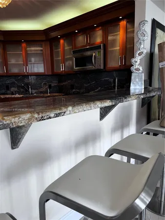 a bedroom with a large bed and a flat tv screen on dresser