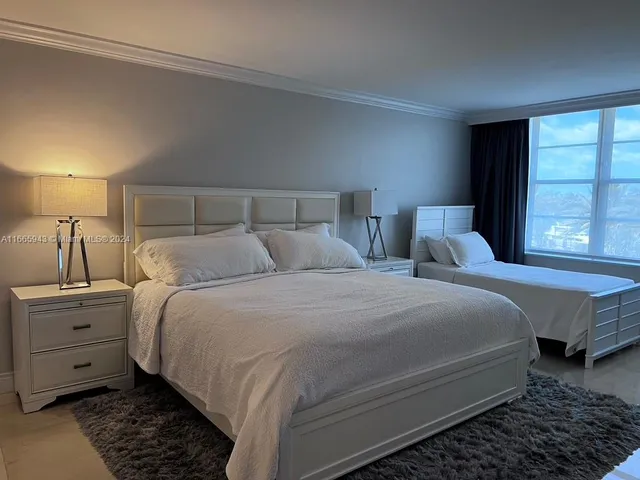 a bathroom with a double vanity sink toilet and a tub