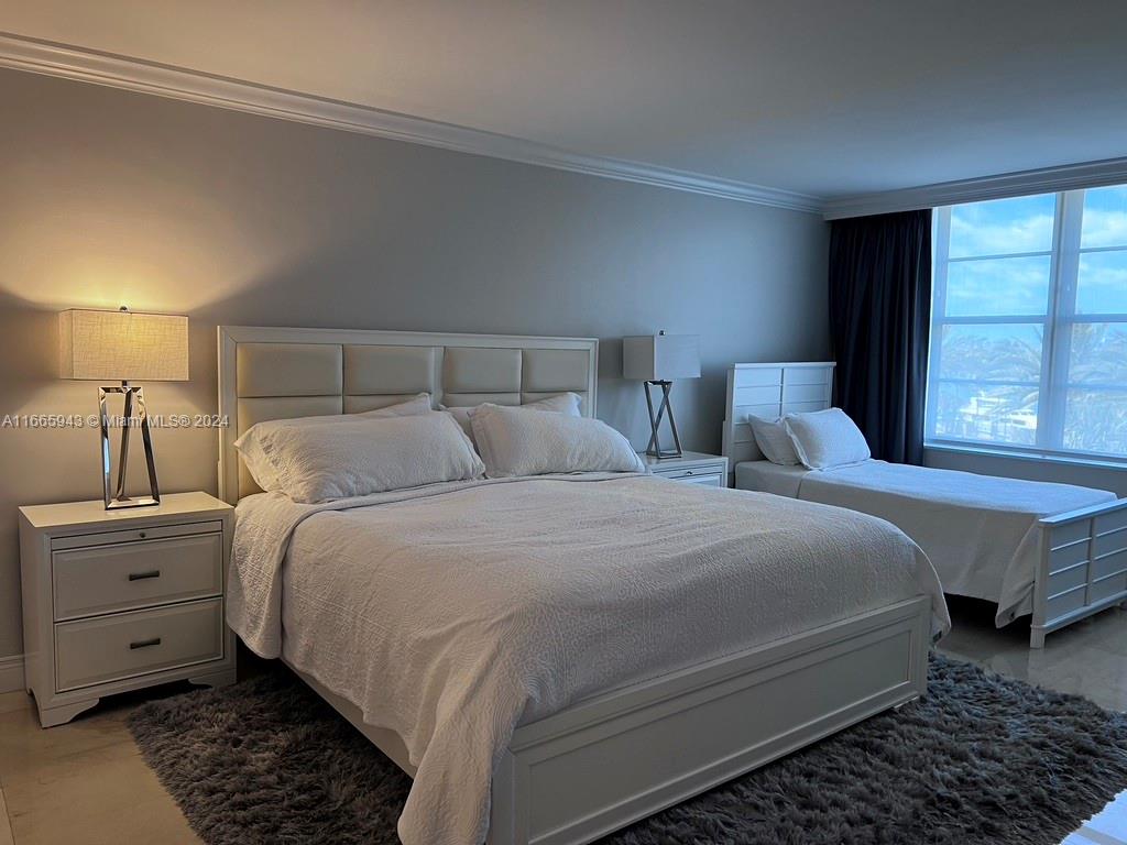 5161 Collins Avenue, Unit 505 Miami Beach, FL 33140 - Photo 22 of 31 a bedroom with bed and window