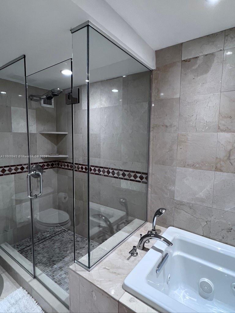 5161 Collins Avenue, Unit 505 Miami Beach, FL 33140 - Photo 25 of 31 a bathroom with a shower and a sink