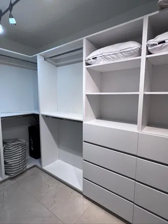 a bedroom with two beds and large window