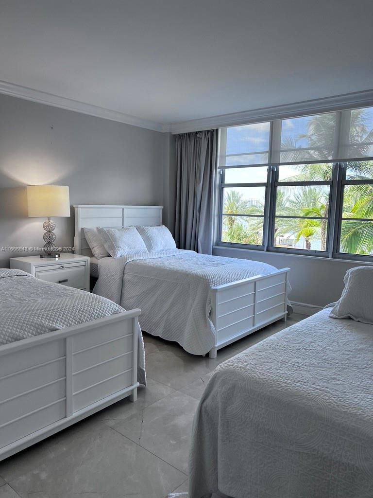 5161 Collins Avenue, Unit 505 Miami Beach, FL 33140 - Photo 28 of 31 a bedroom with two beds and large window