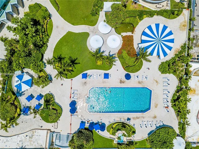 a view of a living room and kitchen with windows