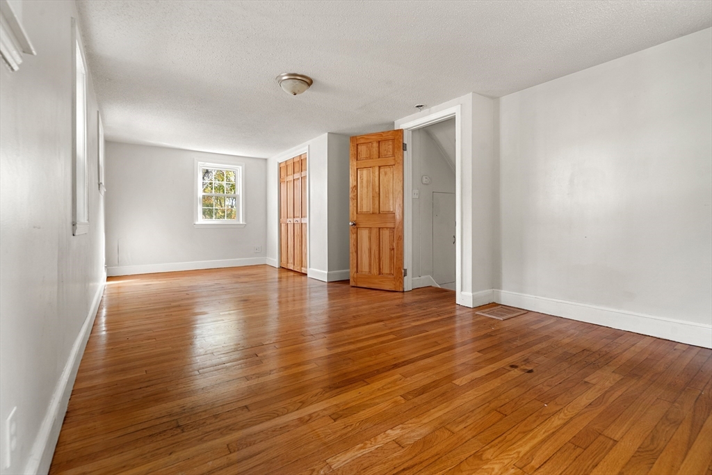 27 Columbia Road Marblehead, MA 01945 - Photo 17 of 30 an empty room with wooden floor and windows