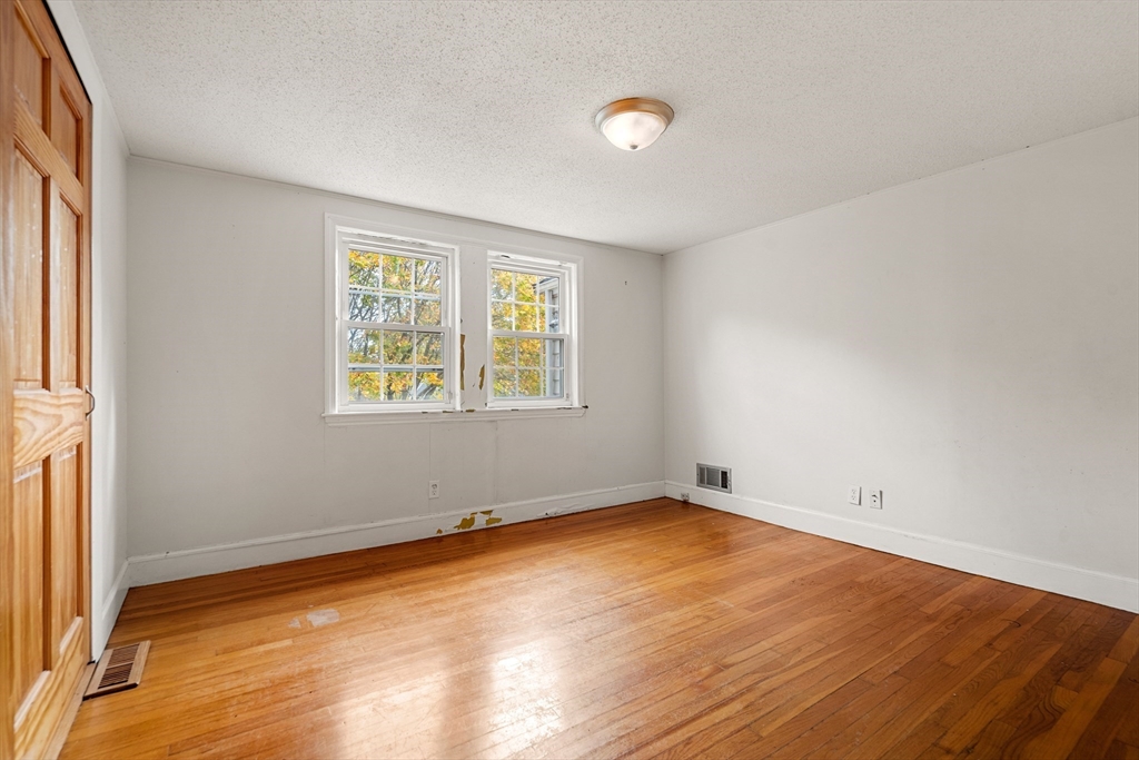 27 Columbia Road Marblehead, MA 01945 - Photo 20 of 30 an empty room with wooden floor and windows