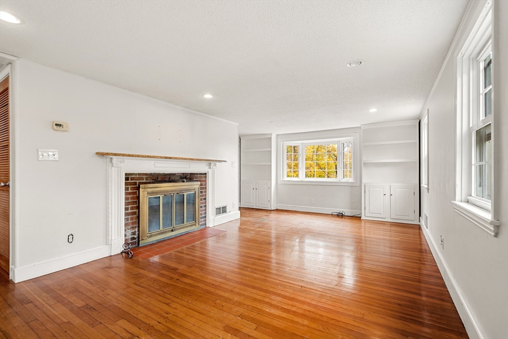 27 Columbia Road Marblehead, MA 01945 - Photo 3 of 30 a view of an empty room with a window and wooden floor