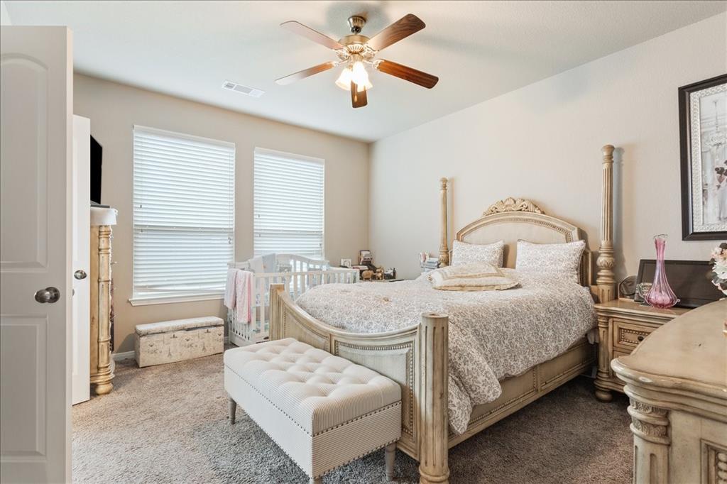 10205 Mickler Lane Waco, TX 76708 - Photo 15 of 35 a bedroom with a bed and a chandelier