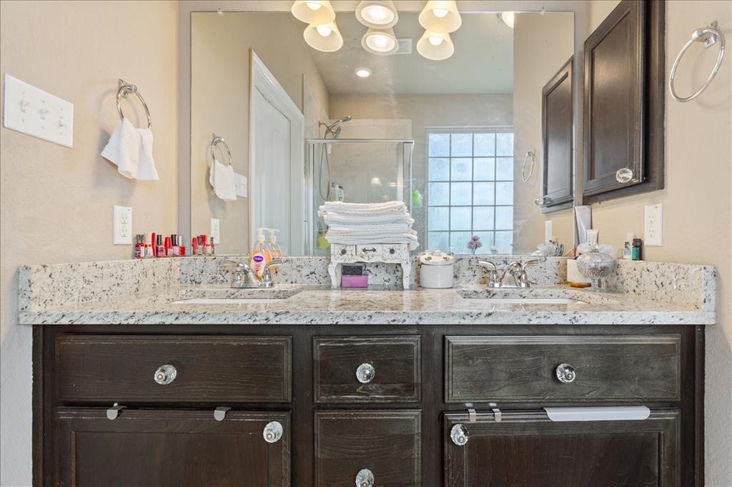 10205 Mickler Lane Waco, TX 76708 - Photo 16 of 35 a bathroom with a granite countertop sink a toilet and a large mirror
