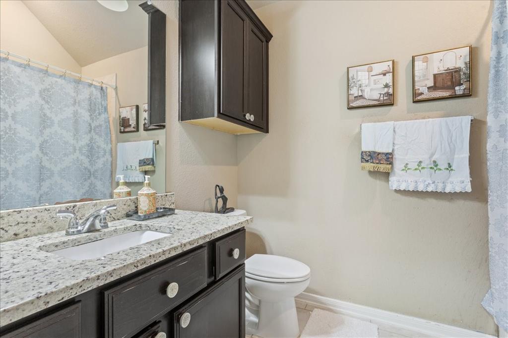 10205 Mickler Lane Waco, TX 76708 - Photo 22 of 35 a bathroom with a granite countertop sink mirror vanity and toilet
