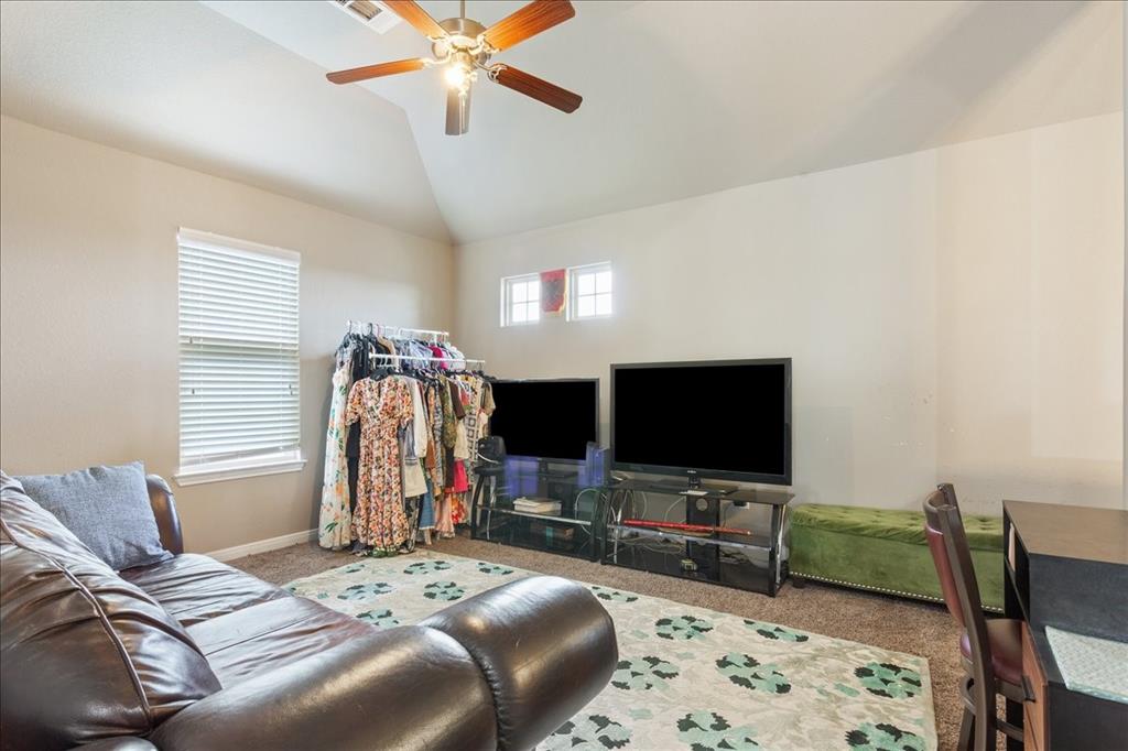 10205 Mickler Lane Waco, TX 76708 - Photo 24 of 35 a bedroom with bed and a flat tv screen on dresser