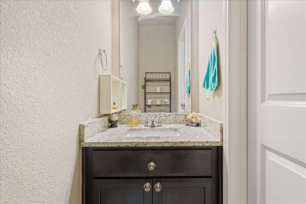 10205 Mickler Lane Waco, TX 76708 - Photo 26 of 35 a bathroom with a granite countertop sink and a mirror