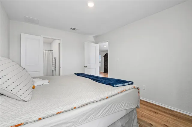 a bedroom with a bed and a mirror