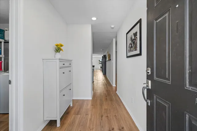 a view of hallway with wooden floor