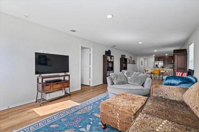 a living room with furniture and a book shelf