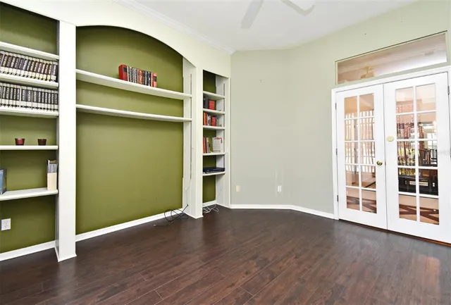 a view of kitchen with stainless steel appliances kitchen island granite countertop a stove a refrigerator a dining table and chairs with wooden floor