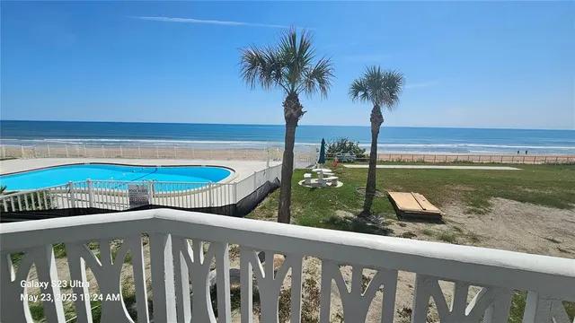 a view of a swimming pool with a table and chairs