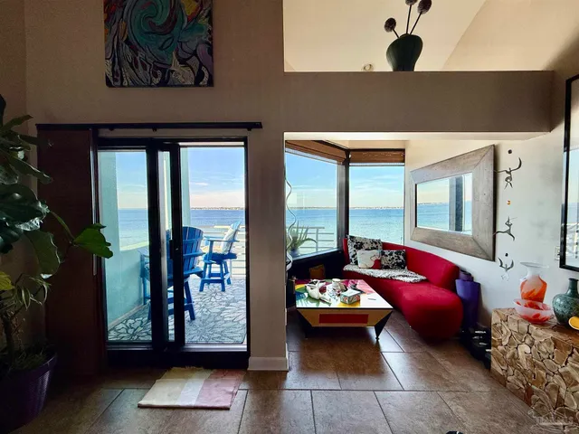 a living room with furniture and floor to ceiling window