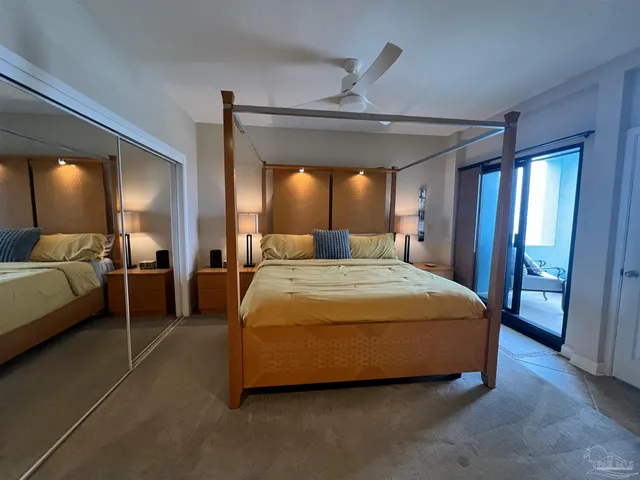 a spacious bedroom with a bed and large mirror