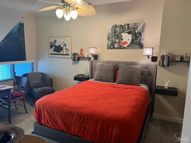 a bedroom with a large bed and a chandelier