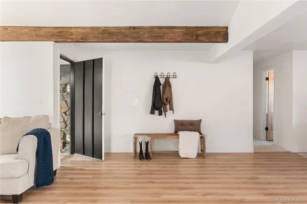 a bedroom with furniture and a wooden floor