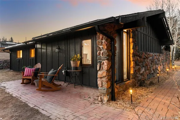 a view of a backyard with wooden fence and a bench