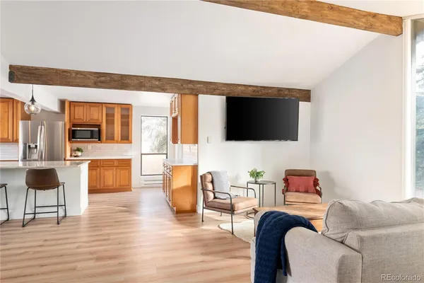 a kitchen with stainless steel appliances a sink a stove cabinets and wooden floor