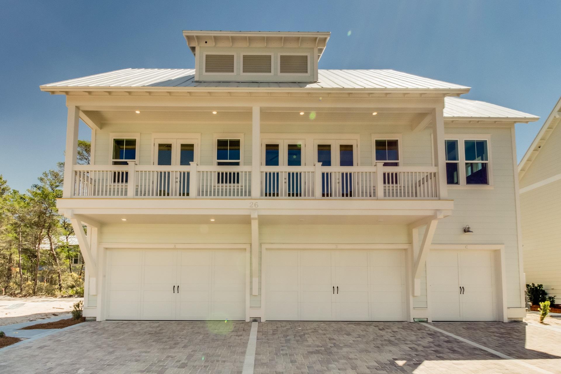 26 Pine Lands Loop Inlet Beach East, Unit A Inlet Beach, FL 32461 - Photo 1 of 25 a front view of a house with a garage