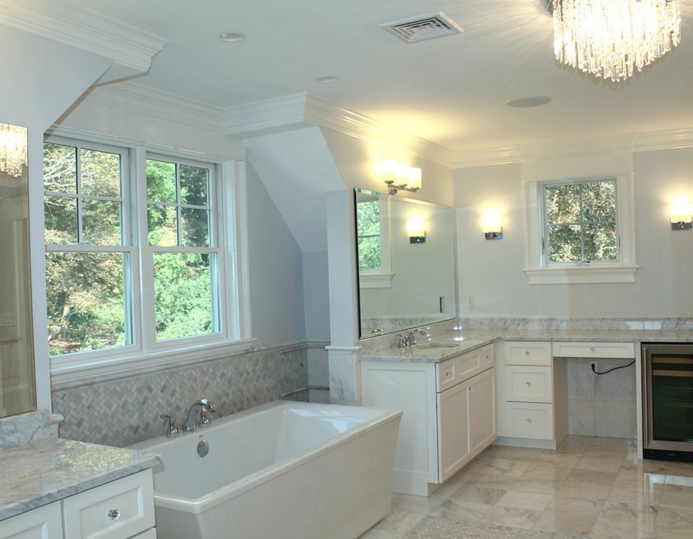8 Burnham Road Lexington, MA 02420 - Photo 16 of 22 a bathroom with a granite countertop bathtub a sink and a window
