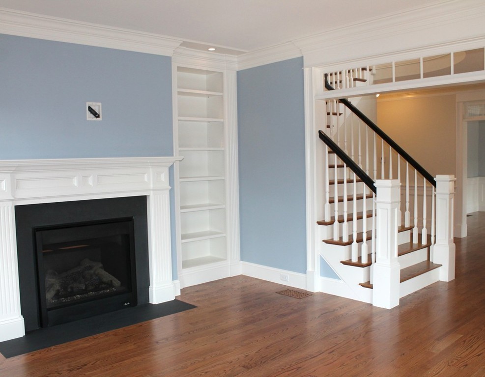 8 Burnham Road Lexington, MA 02420 - Photo 2 of 22 a view of an empty room with wooden floor fireplace and a window
