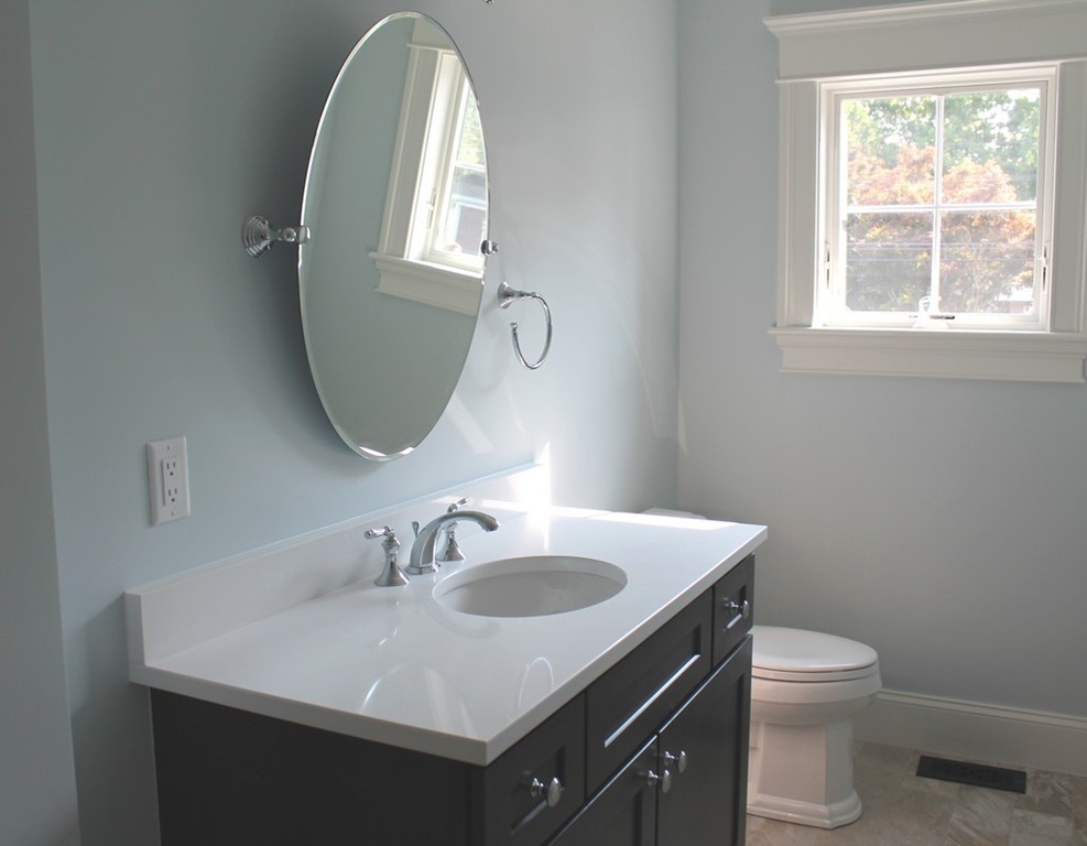 8 Burnham Road Lexington, MA 02420 - Photo 22 of 22 a bathroom with a sink a toilet and a mirror