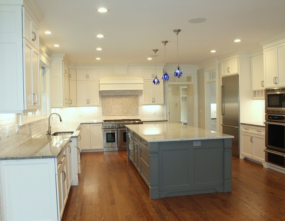 8 Burnham Road Lexington, MA 02420 - Photo 8 of 22 a large kitchen with stainless steel appliances granite countertop a large counter top a stove a sink and a refrigerator