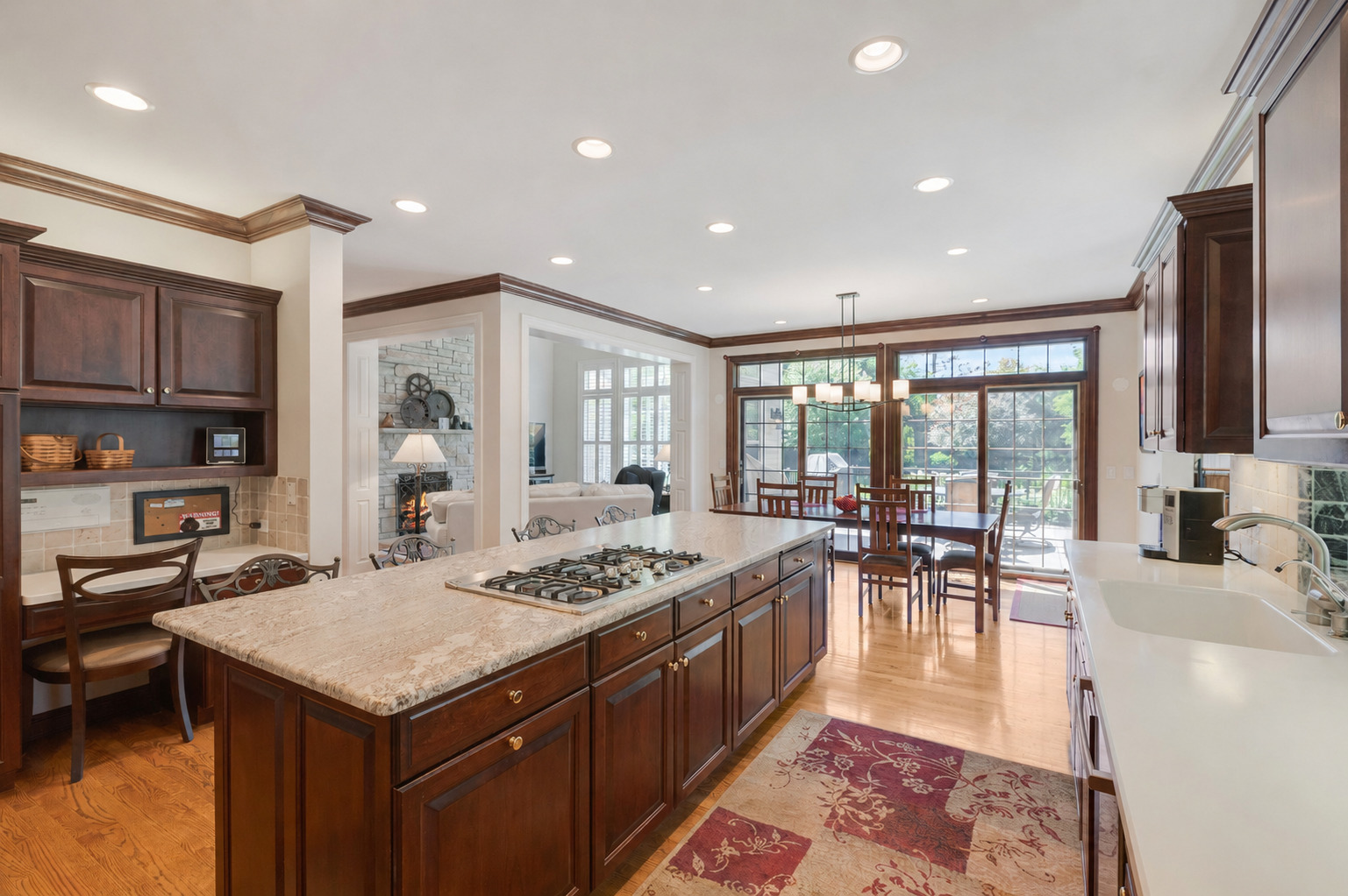 209 Carriage Trail Barrington, IL 60010 - Photo 12 of 42 a large kitchen with kitchen island a stove a sink a dining table and chairs with wooden floor