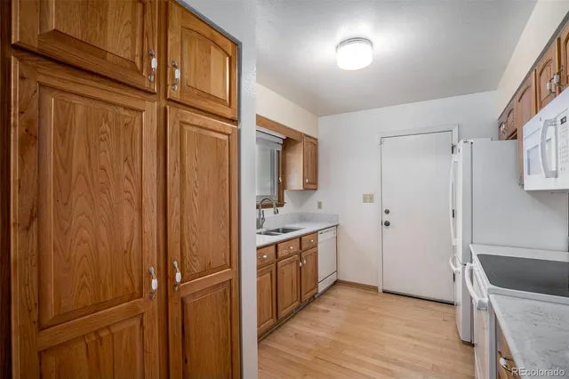 a view of a kitchen with a refrigerator and cabinets