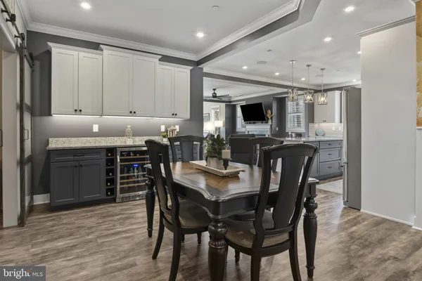 a kitchen with granite countertop a table chairs sink and cabinets