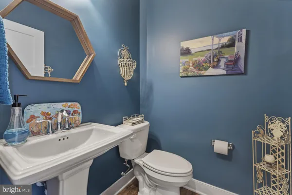 a bathroom with a sink mirror and toilet