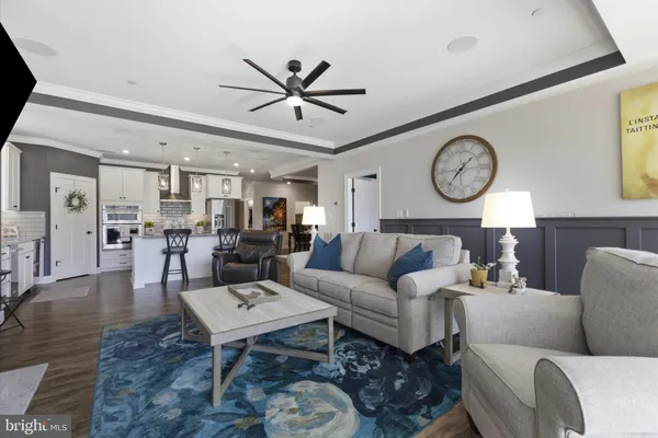 a living room with furniture a clock on wall and a clock