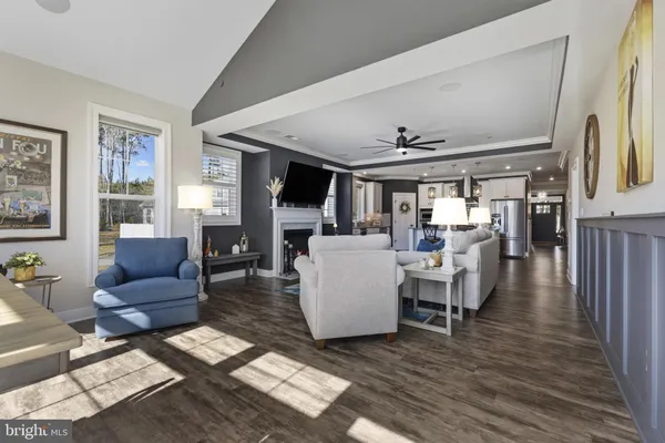 a living room with fireplace furniture and a wooden floor