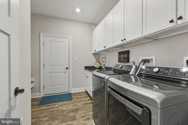 a kitchen with a stove and white cabinets