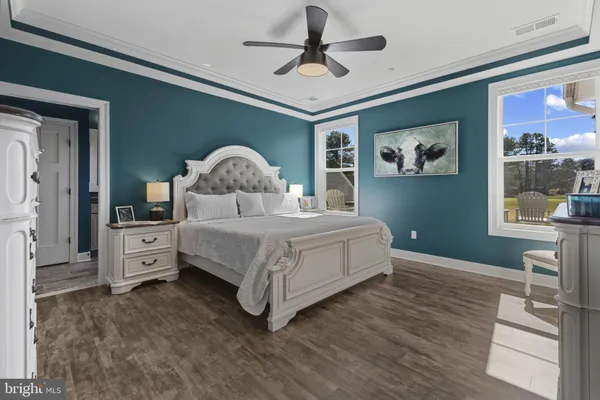 a bedroom with a bed and a chandelier