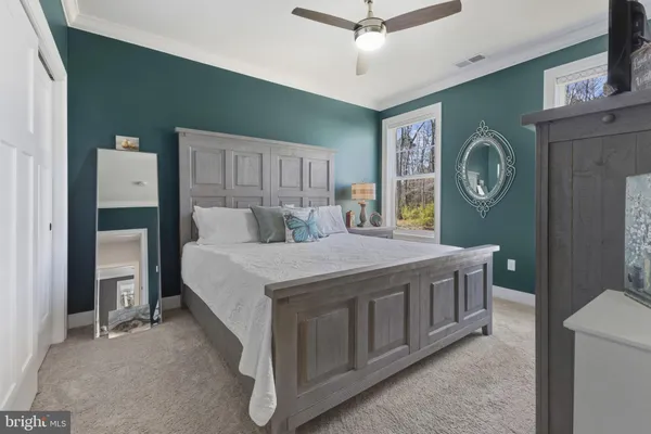 a bed room with a bed mirror and a window